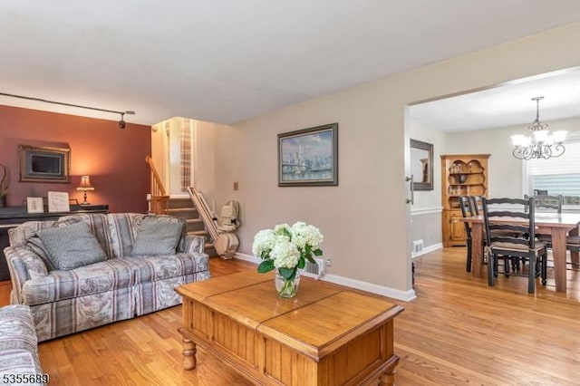 130 Coriell Ave, Fanwood Boro, NJ 07023 - living area featuring a chandelier, light wood-type flooring, stairs, and baseboards