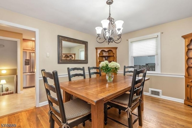 130 Coriell Ave, Fanwood Boro, NJ 07023 - dining area with a chandelier, light wood-style floors, and baseboards