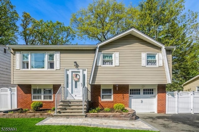 10 Tulsa Trl, Hopatcong Boro, NJ 07843 - split foyer home featuring fence, an attached garage, brick siding, and driveway