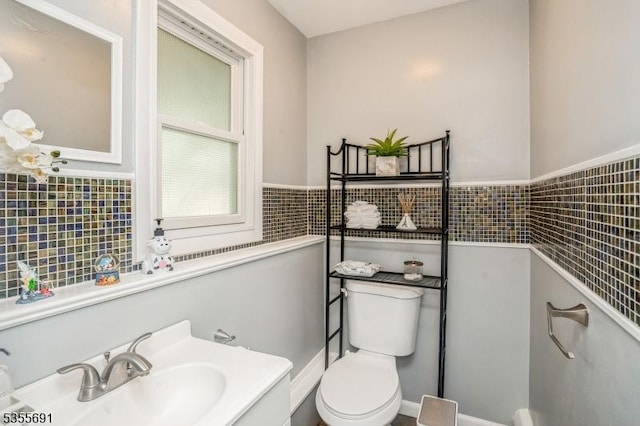 10 Tulsa Trl, Hopatcong Boro, NJ 07843 - half bathroom featuring a sink, toilet, tile walls, and a wainscoted wall