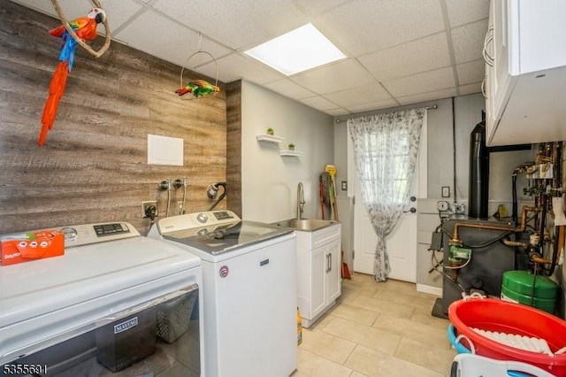 10 Tulsa Trl, Hopatcong Boro, NJ 07843 - clothes washing area featuring washer and dryer, a sink, cabinet space, wooden walls, and light tile patterned flooring