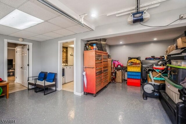 10 Tulsa Trl, Hopatcong Boro, NJ 07843 - garage with washer / clothes dryer, baseboards, and a garage door opener