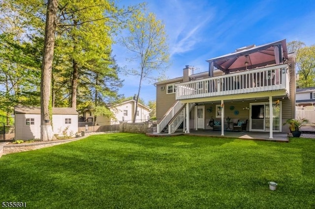 10 Tulsa Trl, Hopatcong Boro, NJ 07843 - rear view of house with a lawn, an outbuilding, fence, stairs, and a wooden deck