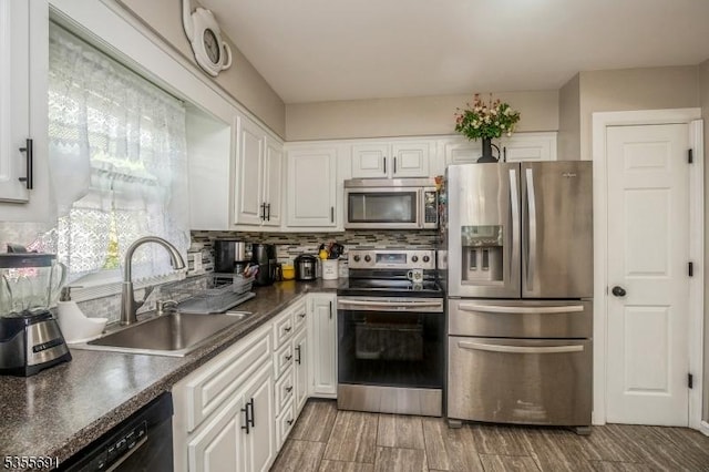 10 Tulsa Trl, Hopatcong Boro, NJ 07843 - kitchen featuring a sink, tasteful backsplash, white cabinetry, dark countertops, and appliances with stainless steel finishes