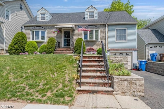 2512 Summit Ter, Linden City, NJ 07036 - new england style home featuring a front lawn, a garage, a shingled roof, and driveway