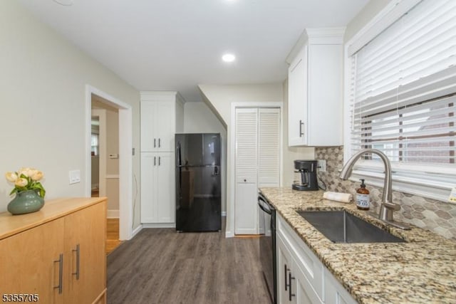 kitchen featuring black appliances, a sink, dark wood finished floors, white cabinets, and recessed lighting