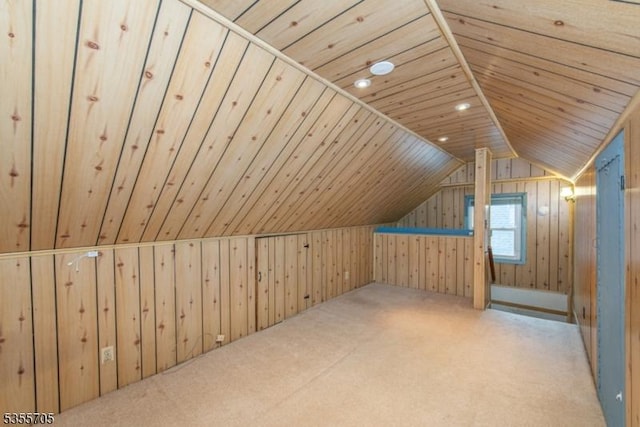 additional living space with wood walls, vaulted ceiling, carpet floors, and wooden ceiling