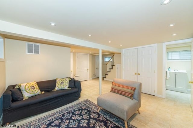 living room with stairs, recessed lighting, and light tile patterned flooring