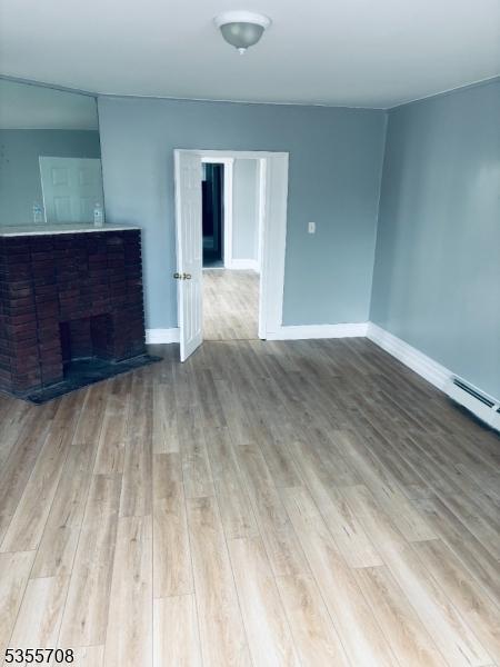 553-555 S 10th St, Newark City, NJ 07103 - unfurnished living room with wood finished floors and baseboards