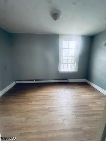 553-555 S 10th St, Newark City, NJ 07103 - empty room with light wood finished floors and baseboards