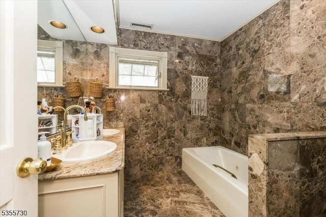 197 Nutley Ave, Nutley Twp, NJ 07110 - full bath with a tub to relax in, tile walls, double vanity, healthy amount of natural light, and ornamental molding