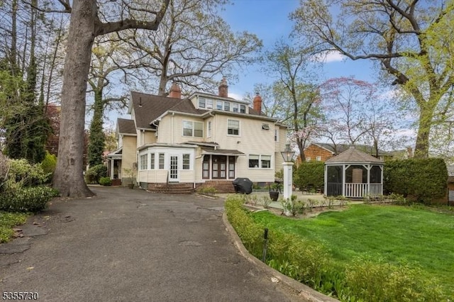 197 Nutley Ave, Nutley Twp, NJ 07110 - view of front of house featuring a gazebo, a chimney, driveway, and a front lawn