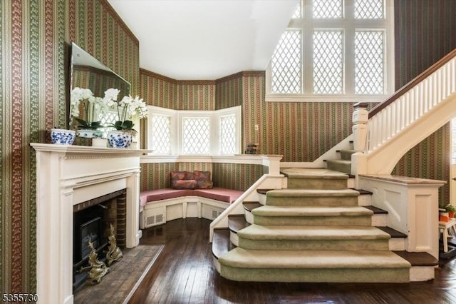 197 Nutley Ave, Nutley Twp, NJ 07110 - stairs featuring wallpapered walls, hardwood / wood-style floors, and a fireplace