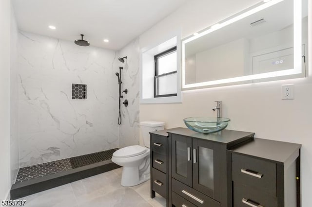 bathroom featuring a marble finish shower, toilet, vanity, and recessed lighting