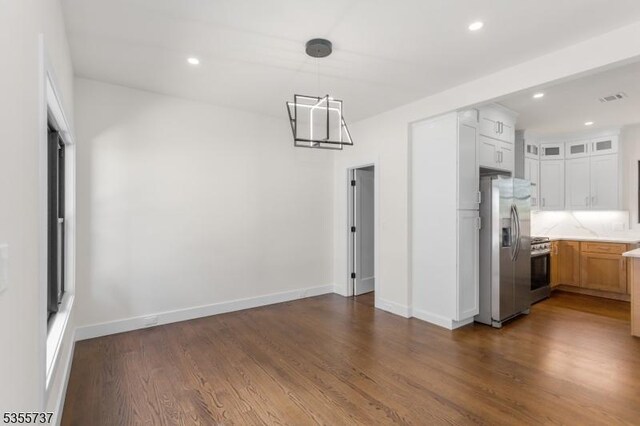 unfurnished dining area with dark wood-style floors, recessed lighting, and baseboards