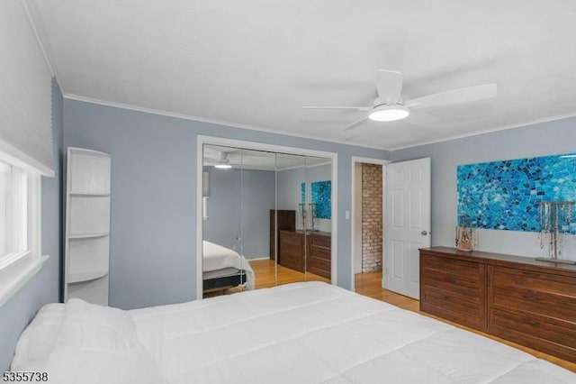 bedroom with a ceiling fan, crown molding, and wood finished floors