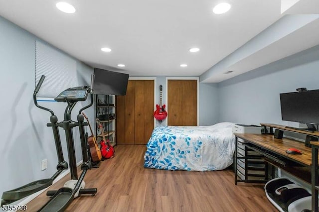 bedroom featuring wood finished floors and recessed lighting