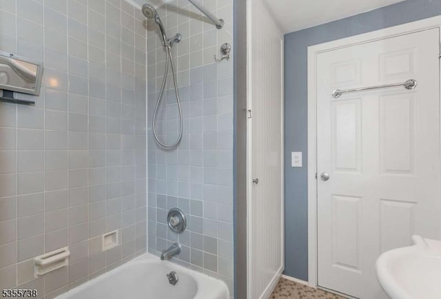 full bath featuring shower / bath combination and baseboards