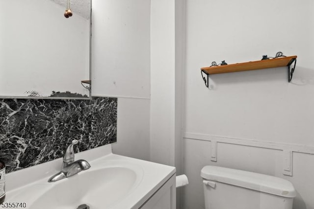 194 James St, Morris Twp, NJ 07960 - bathroom with toilet, vanity, backsplash, and a wainscoted wall