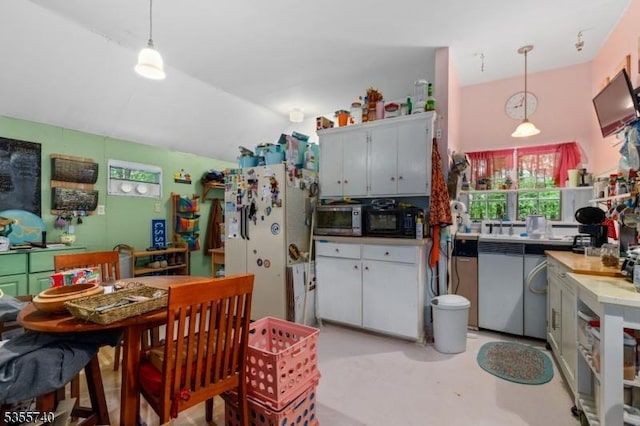 194 James St, Morris Twp, NJ 07960 - kitchen featuring freestanding refrigerator, black microwave, stainless steel microwave, vaulted ceiling, and decorative light fixtures