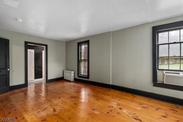 194 James St, Morris Twp, NJ 07960 - unfurnished room featuring radiator, wood-type flooring, cooling unit, and baseboards