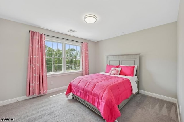 carpeted bedroom with baseboards