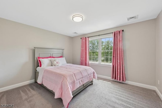 carpeted bedroom featuring baseboards
