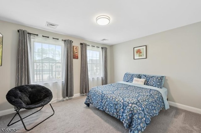 bedroom featuring carpet floors and baseboards