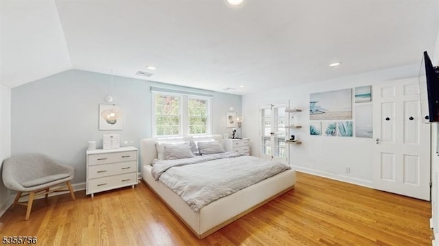 bedroom featuring recessed lighting, baseboards, visible vents, vaulted ceiling, and light wood-type flooring