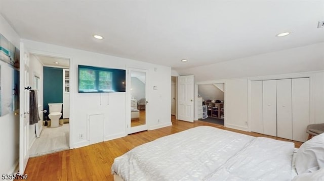 bedroom with recessed lighting, multiple closets, and wood finished floors