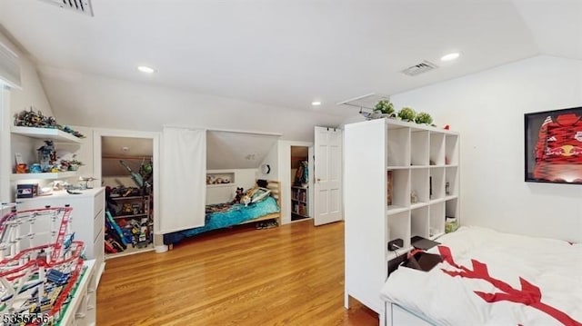 bedroom featuring light wood-style floors, visible vents, lofted ceiling, and recessed lighting
