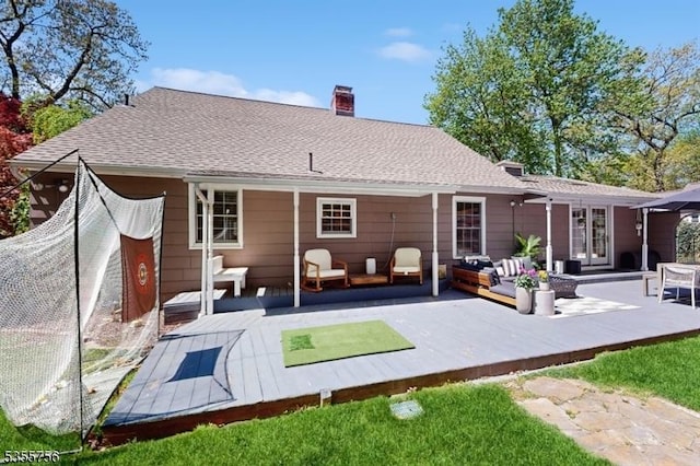 back of property with an outdoor hangout area, a chimney, and a deck