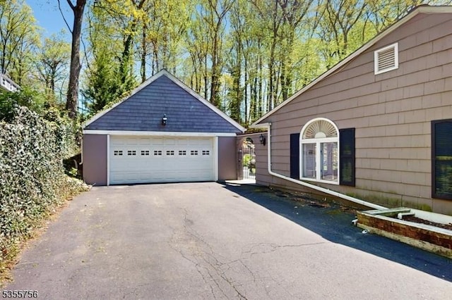 view of home's exterior with an outbuilding and a detached garage