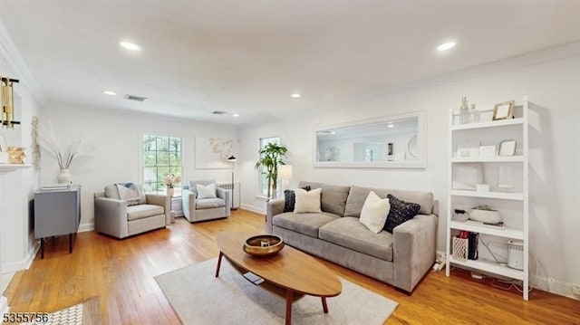 living area with crown molding, light wood-style flooring, visible vents, and recessed lighting