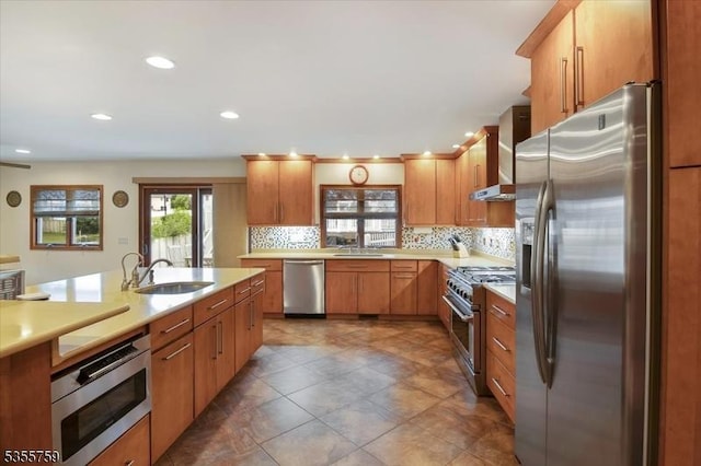 33 Lockwood Pl, Clifton City, NJ 07012 - kitchen with appliances with stainless steel finishes, a sink, wall chimney exhaust hood, light countertops, and backsplash