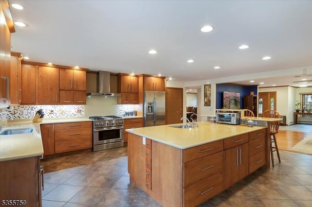 33 Lockwood Pl, Clifton City, NJ 07012 - kitchen featuring stainless steel appliances, wall chimney range hood, a sink, light countertops, and recessed lighting