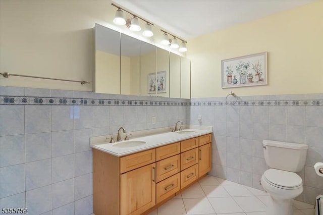 33 Lockwood Pl, Clifton City, NJ 07012 - full bath with tile walls, toilet, double vanity, tile patterned floors, and a wainscoted wall