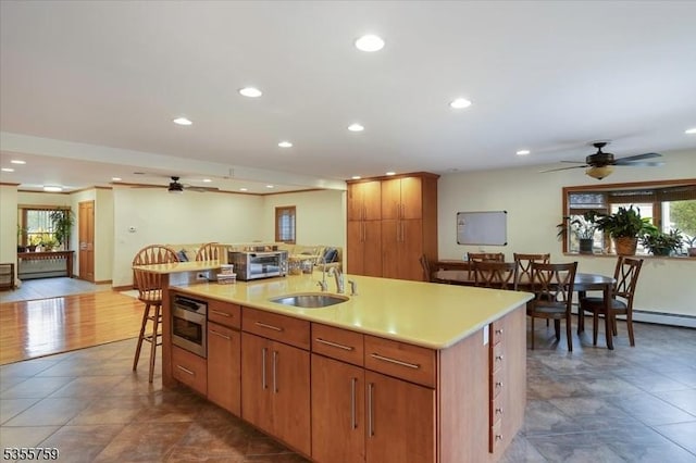 33 Lockwood Pl, Clifton City, NJ 07012 - kitchen with a sink, ceiling fan, a kitchen bar, recessed lighting, and light countertops