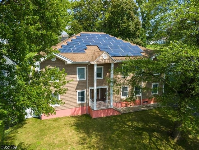 33 Lockwood Pl, Clifton City, NJ 07012 - rear view of property featuring a yard, solar panels, and roof with shingles