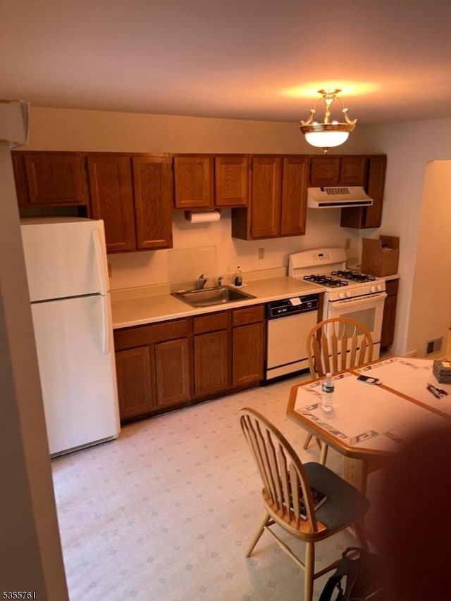 87 Sycamore Ct, Bernards Twp, NJ 07920 - kitchen featuring white appliances, extractor fan, a sink, brown cabinetry, and light countertops