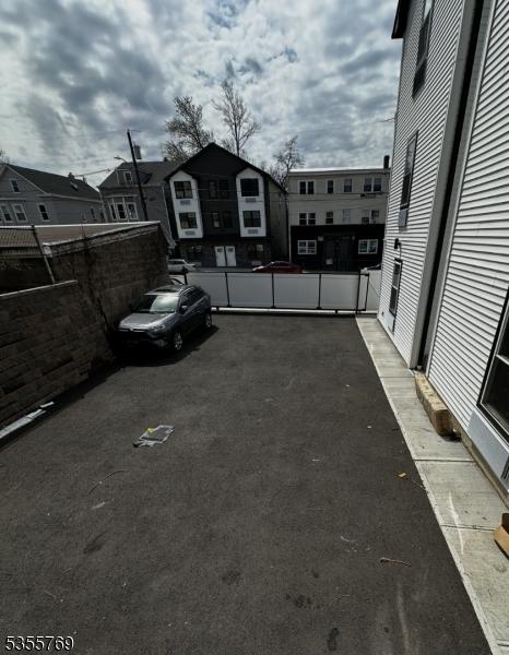 86 N 7th St, Paterson City, NJ 07522 - view of car parking featuring fence