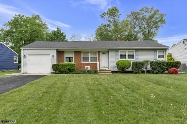 single story home featuring an attached garage, asphalt driveway, a front yard, central air condition unit, and brick siding