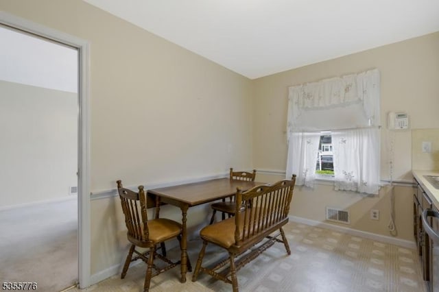 dining room with baseboards and light floors