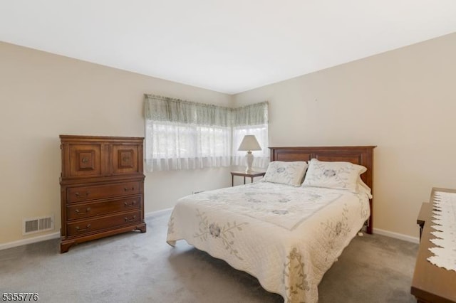 carpeted bedroom featuring baseboards