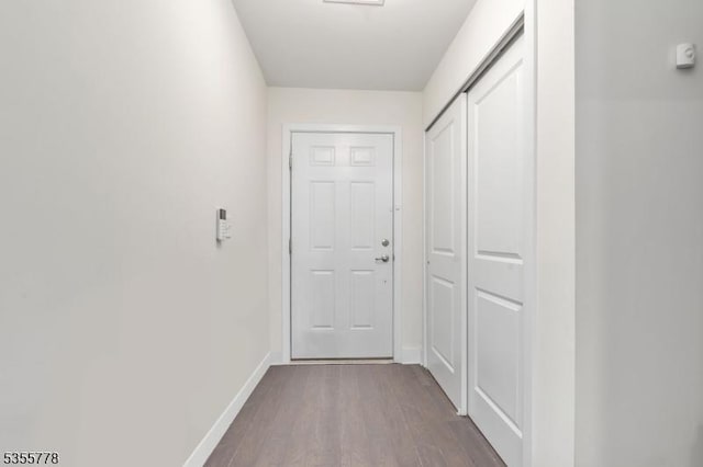 entryway with baseboards and dark wood-style floors
