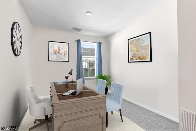 carpeted office space featuring baseboards and visible vents