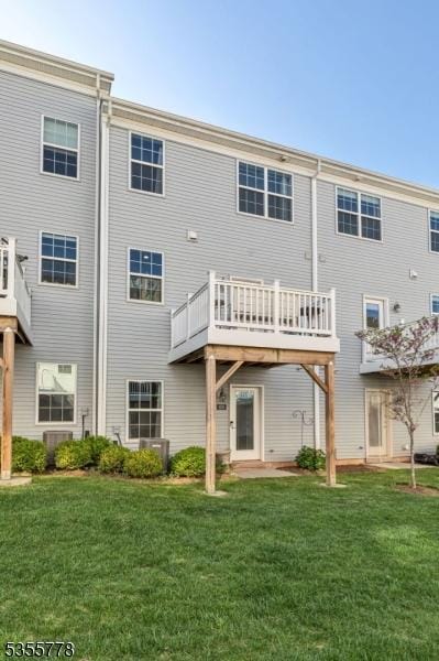 rear view of property featuring a yard