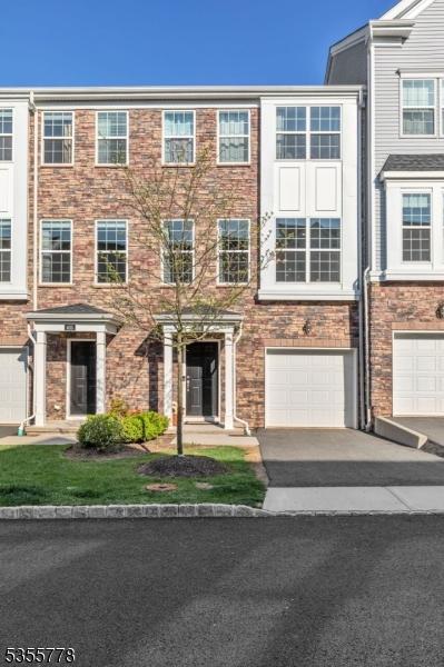 view of property with an attached garage and driveway