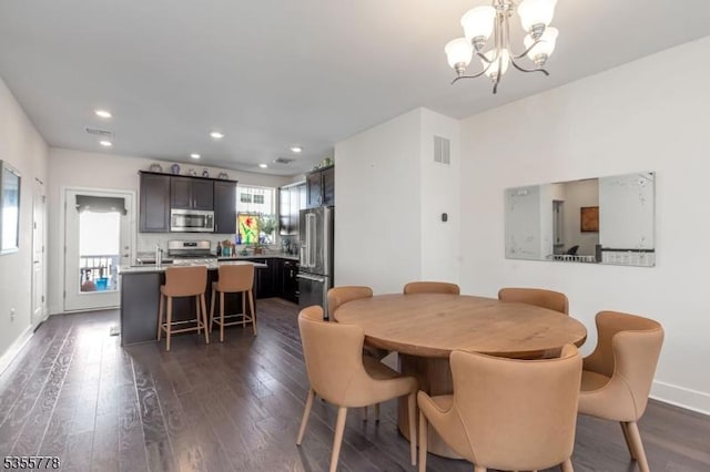 dining space featuring visible vents, recessed lighting, dark wood finished floors, a chandelier, and baseboards