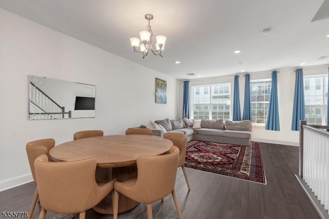 dining room with baseboards, dark wood finished floors, and a chandelier